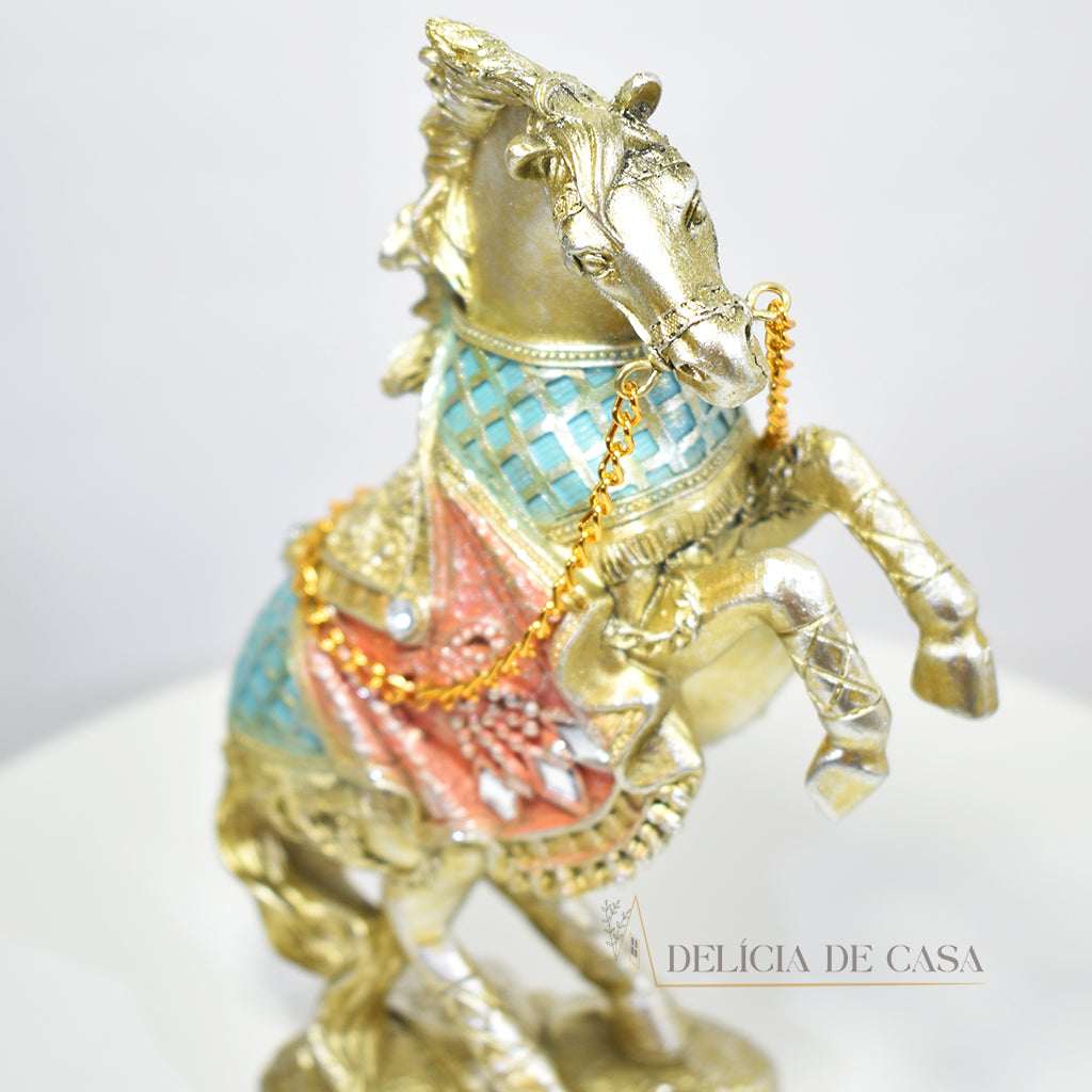 Estatueta decorativa de cavalo em resina com detalhes dourados e coloridos. Um design elegante para valorizar a decoração de salas, escritórios ou ambientes sofisticados