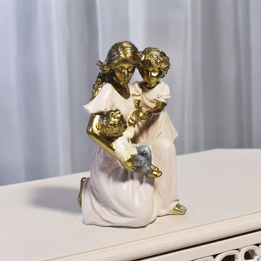 Escultura decorativa em resina representando mãe ajoelhada com dois filhos, simbolizando amor, cuidado, proteção e união familiar.