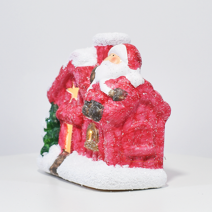 Casinha decorativa de Natal com Papai Noel e neve, feita em resina com glitter e luz interna, 12 cm de altura, nas cores bege, vermelho e cinza.